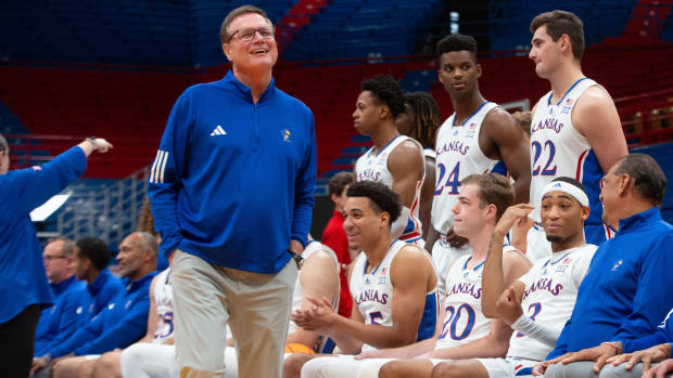 Kansas men's basketball head coach Bill Self jokes with players before a group photo at Wednesday's media day inside Allen Fieldhouse.